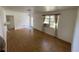Bright living room with hardwood floors and a window with curtains at 8211 Diagonal N Rd, St Petersburg, FL 33702