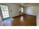 Cozy living room with hardwood floors, a window, and a door to the outside at 8211 Diagonal N Rd, St Petersburg, FL 33702