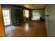 Spacious living room features light-colored sofa, wood floors, and bright natural light from windows at 8211 Diagonal N Rd, St Petersburg, FL 33702