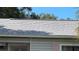 Close-up of the roof, showcasing the shingle texture and overall condition, with some climbing vegetation at 8211 Diagonal N Rd, St Petersburg, FL 33702