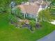 Beautiful aerial view of a well-landscaped home featuring mature trees, vibrant lawn and water fountain at 8336 Monaco Dr # A, Port Richey, FL 34668