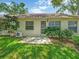 Backyard featuring a well-maintained lawn and landscaping around the exterior of the home at 8336 Monaco Dr # A, Port Richey, FL 34668