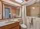 Bathroom featuring a walk-in bathtub and vanity with a spacious sink and large mirror at 8336 Monaco Dr # A, Port Richey, FL 34668