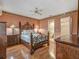 This spacious bedroom has a wrought iron bed frame and is next to a bathroom and walk-in closet at 8336 Monaco Dr # A, Port Richey, FL 34668