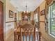Traditional dining room features a wooden table with seating for eight, a china cabinet, and a bright window at 8336 Monaco Dr # A, Port Richey, FL 34668