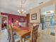Dining room with large wooden table, ornate chairs, chandelier, leading to living room and kitchen at 8336 Monaco Dr # A, Port Richey, FL 34668