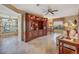 Open-concept living area with tile floors and built-in shelving, perfect for entertaining and relaxation at 8336 Monaco Dr # A, Port Richey, FL 34668