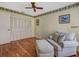 Comfortable living room features a cozy chair with ottoman and a closet with bright natural light from window at 8336 Monaco Dr # A, Port Richey, FL 34668