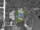 A birds eye shot with selective coloring shows the roof, yard, pool, and patio at 8711 Crescent Forest Blvd, New Port Richey, FL 34654