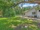 Well-maintained backyard with green lawn, mature trees, and landscaping surrounding the property at 8711 Crescent Forest Blvd, New Port Richey, FL 34654