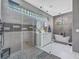 Modern bathroom with a glass-enclosed shower, dual vanity, and a soaking tub at 8711 Crescent Forest Blvd, New Port Richey, FL 34654