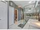 Bathroom showcasing a toilet, glass-enclosed shower, and double vanity at 8711 Crescent Forest Blvd, New Port Richey, FL 34654