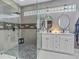 Bathroom featuring a glass-enclosed shower with dual sinks and modern mirrors at 8711 Crescent Forest Blvd, New Port Richey, FL 34654