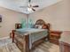 Bedroom with wood-look floors featuring a dark wood bed with ornate detailing and matching dressers at 8711 Crescent Forest Blvd, New Port Richey, FL 34654