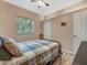 Bedroom with neutral walls that features a full-size bed, a ceiling fan, and wood-look floors at 8711 Crescent Forest Blvd, New Port Richey, FL 34654