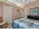 Comfortable bedroom showcasing a bed with a black metal frame, neutral walls, and wood-look floors at 8711 Crescent Forest Blvd, New Port Richey, FL 34654