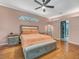 Comfortable bedroom featuring hardwood floors, a sleek bed frame, and natural light at 8711 Crescent Forest Blvd, New Port Richey, FL 34654
