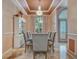 Elegant dining room with a chandelier, tray ceiling, and large window at 8711 Crescent Forest Blvd, New Port Richey, FL 34654