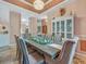 Spacious dining room with seating for eight, beautiful decor, and skylights nearby at 8711 Crescent Forest Blvd, New Port Richey, FL 34654