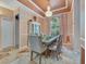 Charming dining room featuring a chandelier, light walls, and ample natural light at 8711 Crescent Forest Blvd, New Port Richey, FL 34654