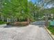 Community entrance featuring an ornate gate, brick pillars, and meticulously maintained landscaping, offering secure access at 8711 Crescent Forest Blvd, New Port Richey, FL 34654