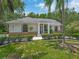 Beautiful single-story home featuring well-manicured landscaping and an inviting entrance with stately columns and a brick facade at 8711 Crescent Forest Blvd, New Port Richey, FL 34654