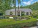 Beautiful home showcasing a well-manicured front yard, lush greenery, and a charming brick mailbox enhancing curb appeal at 8711 Crescent Forest Blvd, New Port Richey, FL 34654