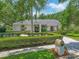 Beautiful home showcasing a well-manicured front yard, lush greenery, and a charming brick mailbox enhancing curb appeal at 8711 Crescent Forest Blvd, New Port Richey, FL 34654
