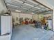 Well-lit garage featuring ample storage, a work area, and an open layout for convenience at 8711 Crescent Forest Blvd, New Port Richey, FL 34654