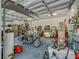 Well-lit garage featuring ample storage, a work area, and an open layout for convenience at 8711 Crescent Forest Blvd, New Port Richey, FL 34654