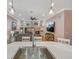 Stylish kitchen with a stainless steel sink, pendant lighting, and an open view to the cozy living area with a fireplace at 8711 Crescent Forest Blvd, New Port Richey, FL 34654