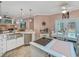 Bright kitchen featuring stainless steel appliances, pendant lighting, and an island cooktop at 8711 Crescent Forest Blvd, New Port Richey, FL 34654