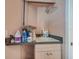Bright laundry room featuring a utility sink, cleaning supplies, and convenient storage space above the counter at 8711 Crescent Forest Blvd, New Port Richey, FL 34654