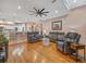 Open living room with hardwood floors, comfortable seating, and easy access to the dining area at 8711 Crescent Forest Blvd, New Port Richey, FL 34654
