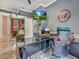 Modern home office featuring an oversized desk, ergonomic chair, and large screen TV for an immersive work experience at 8711 Crescent Forest Blvd, New Port Richey, FL 34654