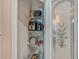 Well-organized pantry with shelving providing ample storage for kitchen essentials, behind a decorative glass door at 8711 Crescent Forest Blvd, New Port Richey, FL 34654