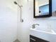 The bathroom's walk-in shower features modern fixtures, with stylish white tiles, with a unique texture at 8848 56Th N Way, Pinellas Park, FL 33782