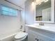 Bright bathroom featuring a shower over tub, white tiled walls, and a vanity with a framed mirror at 8848 56Th N Way, Pinellas Park, FL 33782