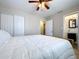 This spacious bedroom has a ceiling fan and ample closet space, plus a view to an ensuite bathroom at 8848 56Th N Way, Pinellas Park, FL 33782