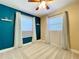 This bedroom is decorated with an accent wall and lots of natural light from two windows at 8848 56Th N Way, Pinellas Park, FL 33782