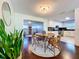 Open dining room features a wooden table and chairs with view into living and kitchen area at 8848 56Th N Way, Pinellas Park, FL 33782