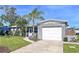 Well-kept home exterior with lush lawn, beautiful landscaping, and attached one car garage at 8848 56Th N Way, Pinellas Park, FL 33782