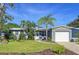 Home exterior displaying well-manicured lawn, beautiful landscaping, and attached one car garage at 8848 56Th N Way, Pinellas Park, FL 33782