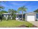Charming single story home with a manicured lawn, tropical landscaping, and an attached garage in a desirable neighborhood at 8848 56Th N Way, Pinellas Park, FL 33782