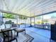 Spacious screened-in porch furnished with comfortable seating, string lights, and views of the backyard at 8848 56Th N Way, Pinellas Park, FL 33782
