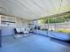 Comfortable screened-in porch with string lights, seating, and backyard access at 8848 56Th N Way, Pinellas Park, FL 33782