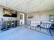 Screened porch with seating, a TV, storage, string lights, and outdoor decor at 8848 56Th N Way, Pinellas Park, FL 33782