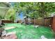 Artificial turf backyard featuring playset and fencing at 9041 58Th N St, Pinellas Park, FL 33782