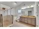 Updated bathroom featuring a glass enclosed shower, soaking tub, and a double sink vanity at 9041 58Th N St, Pinellas Park, FL 33782
