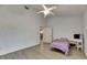 Bright bedroom with light wood floors, ceiling fan, and view into the hall at 9041 58Th N St, Pinellas Park, FL 33782